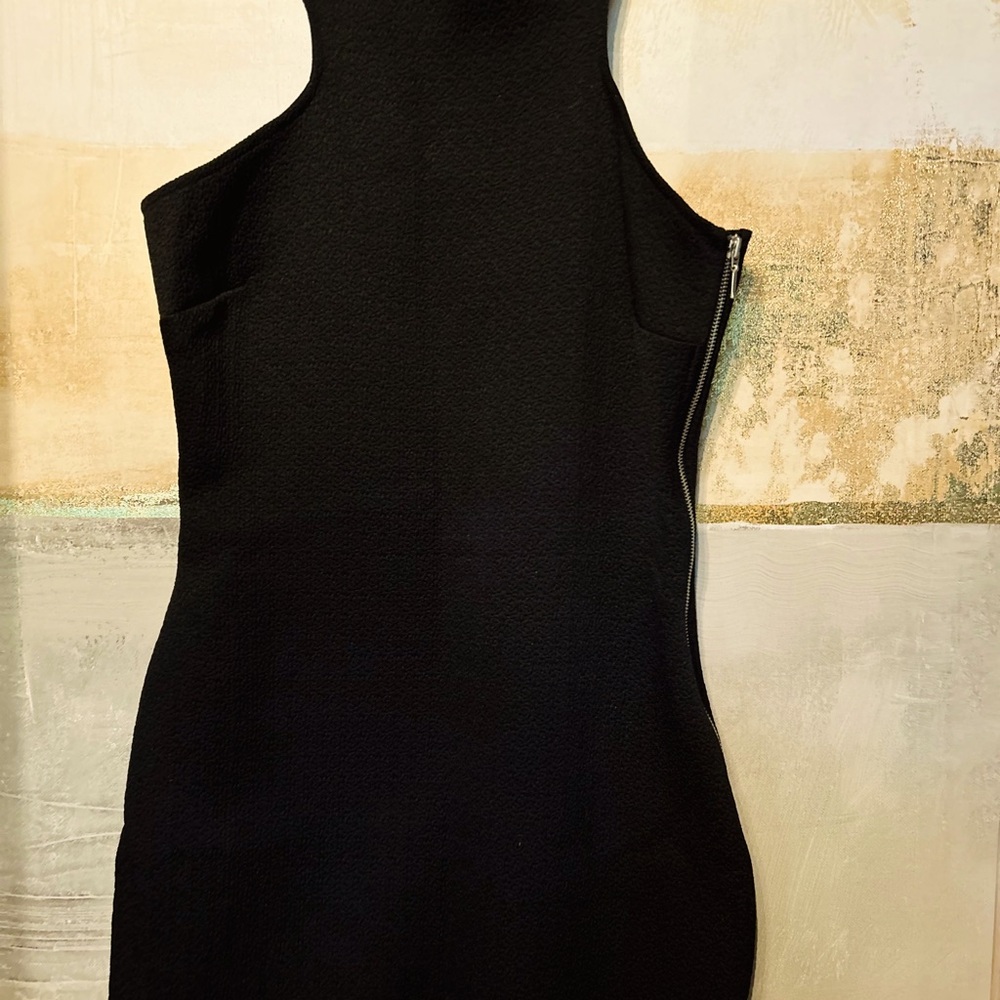 Stylish black cocktail dress with a metal lock